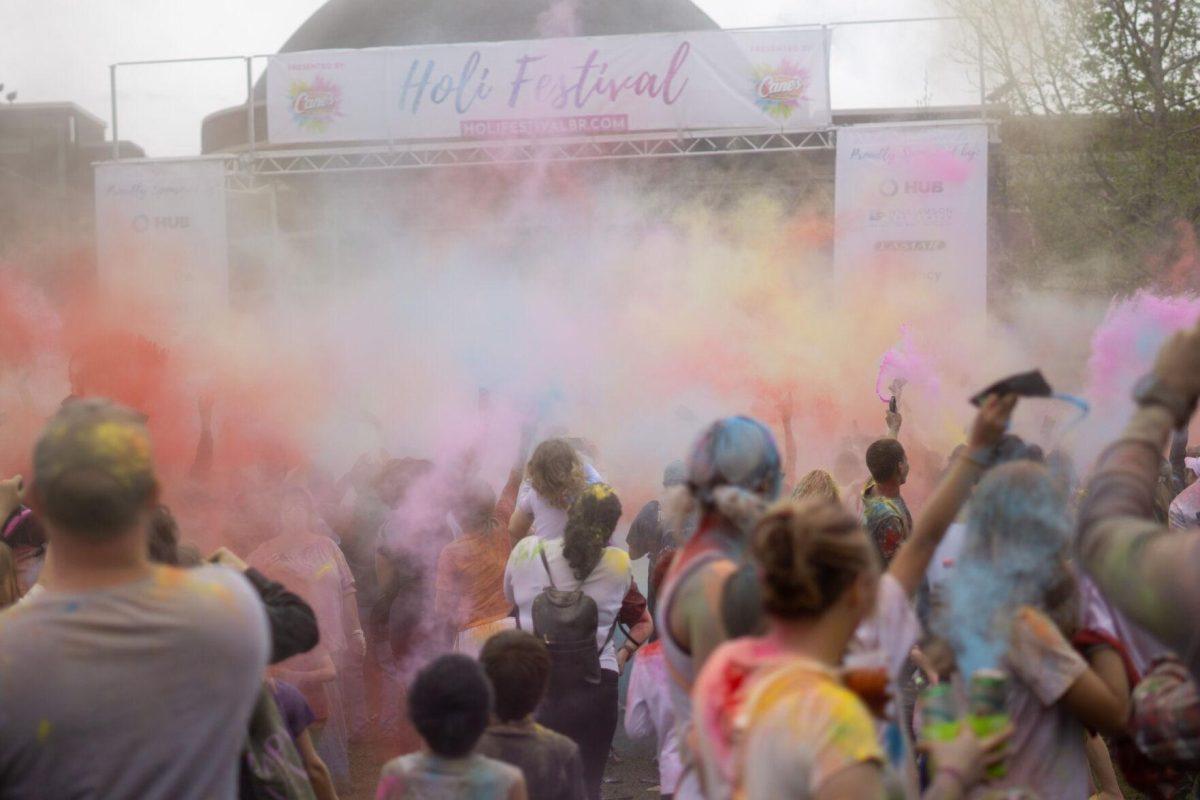 Holi festival participants throw powder Saturday, March 9, 2024, at the Holi Festival at Repentance Park in Baton Rouge La.