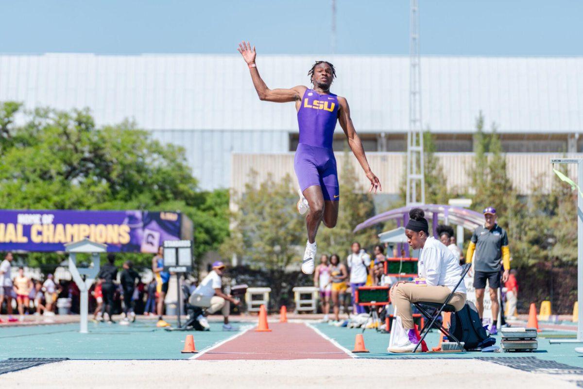 LSU track and field jumps senior Ji'eem Bullock flies through the air Saturday, March 23, 2024, during the Keyth Talley Invitational at the Bernie Moore Track Stadium in Baton Rouge, La.