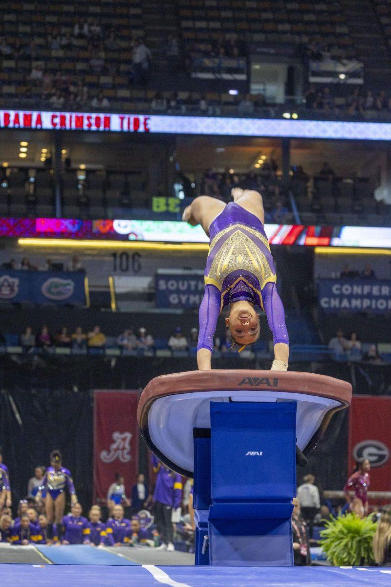 LSU gymnastics junior all-around Aleah Finnegan pounces onto the vault Saturday, March 23, 2024, during LSU's 198.075 victory in the 2024 SEC Gymnastics Championship in the Smoothie King Center in New Orleans, La.