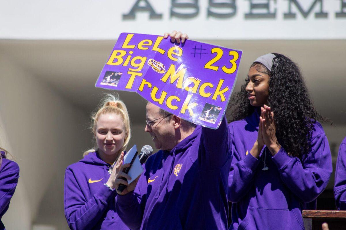 The announcer pulls a sign from the crowd that reads "LeLe #23 Big Mack Truck" at the Sweet Sixteen Sendoff on Thursday, March 28, 2024, outside the Pete Maravich Assembly Center in Baton Rouge, La.