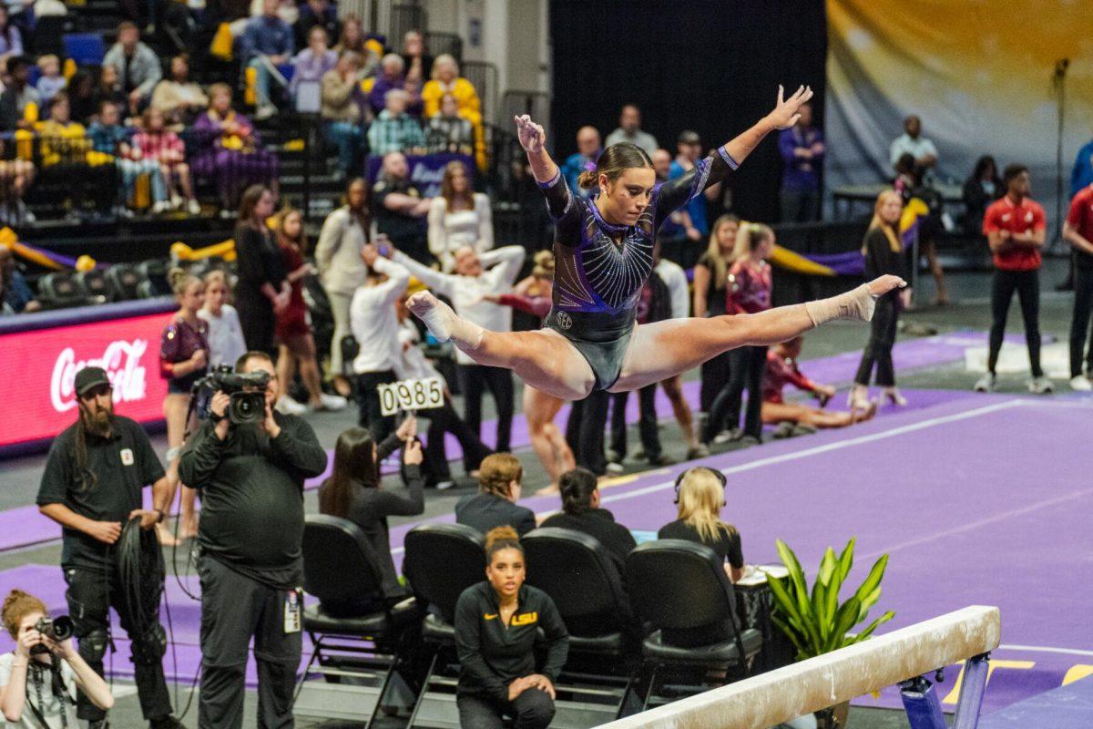 LSU gymnastics all-around junior Alexis Jeffrey performs a split in midair Friday, March 1, 2024, during LSU&#8217;s 198.325-197.325 win against Alabama in the Pete Maravich Assembly Center in Baton Rouge, La.