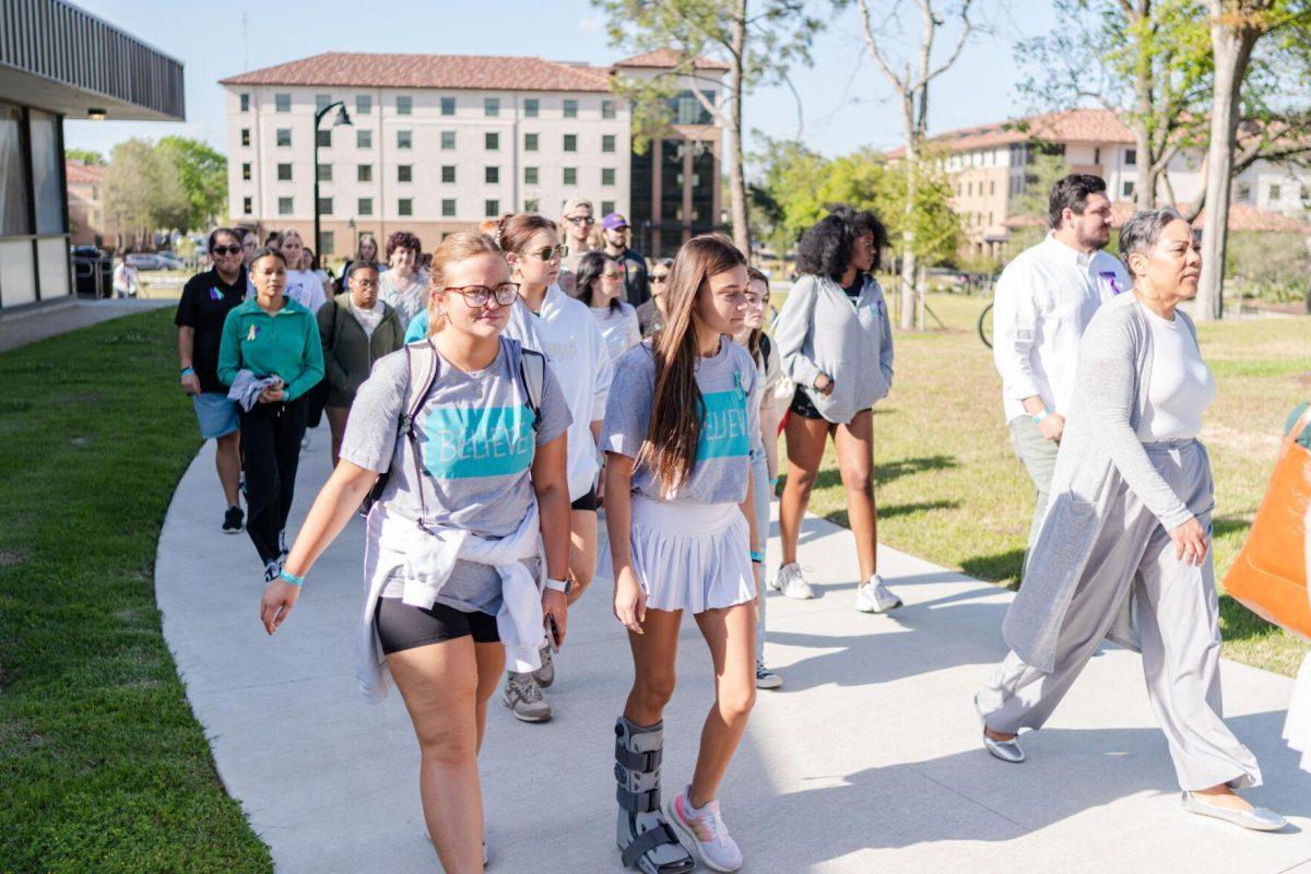 Attendees walk the route in silence Tuesday, March 26, 2024, at the Believe March on LSU's campus.