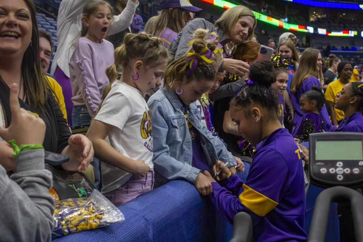 LSU gymnastics freshman all-around Konnor McClain signs autographs for fans Saturday, March 23, 2024, following LSU's 198.075 victory in the 2024 SEC Gymnastics Championship in the Smoothie King Center in New Orleans, La.
