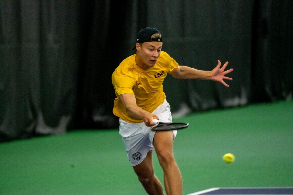 LSU men's tennis freshman Aleksi Lofman hits a forehand during his 5-7 doubles match against Ole Miss Friday, March 8, 2024, at the LSU tennis complex on Gourrier Avenue in Baton Rouge, La.