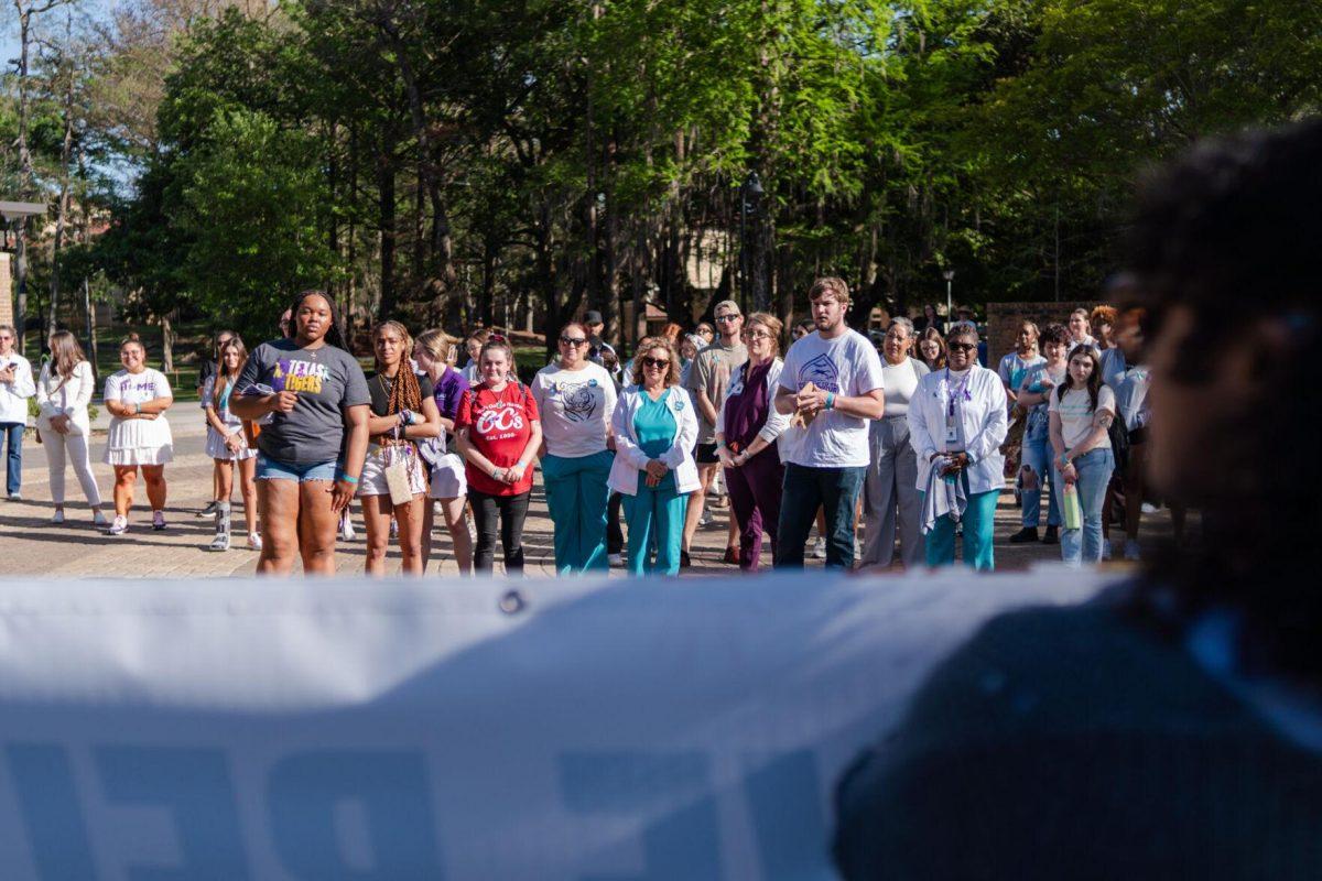 Attendees listen to Director of the Lighthouse Program Kreslyn Kelley-Ellis speak after the march Tuesday, March 26, 2024, at the Believe March on LSU's campus.