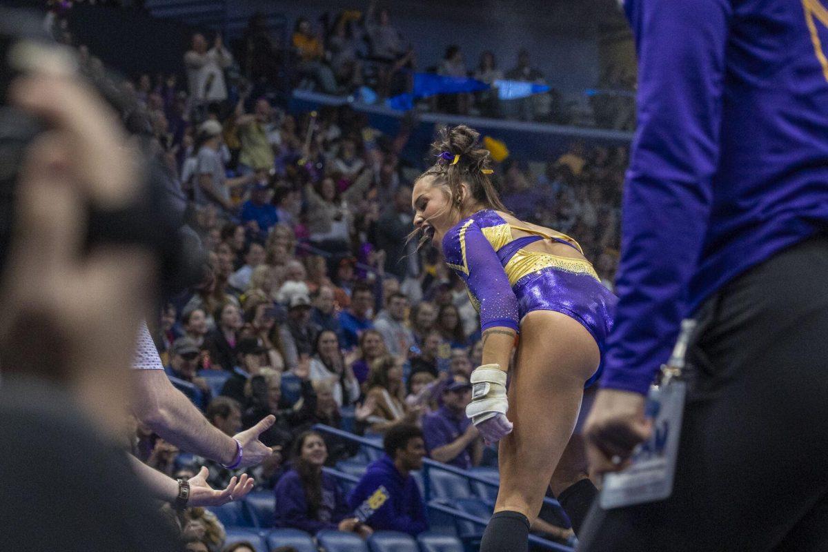 LSU gymnastics junior all-around KJ Johnson celebrates after her vault routine Saturday, March 23, 2024, during LSU's 198.075 victory in the 2024 SEC Gymnastics Championship in the Smoothie King Center in New Orleans, La.