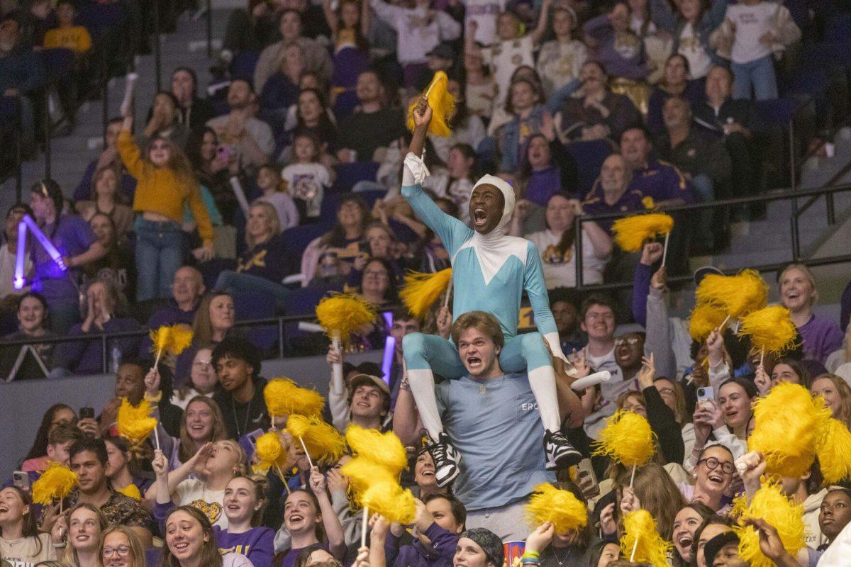A LSU gymnastics fan dressed as Frozone lets out a cheer while sitting on top of another fan's shoulder Friday, March 1, 2024, during LSU's 198.325-197.325 win over Alabama in the Pete Maravich Assembly Center.