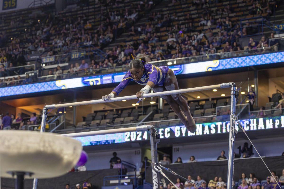 LSU gymnastics graduate student Kiya Johnson goes through her uneven bars routine Saturday, March 23, 2024, during LSU's 198.075 victory in the 2024 SEC Gymnastics Championship in the Smoothie King Center in New Orleans, La.