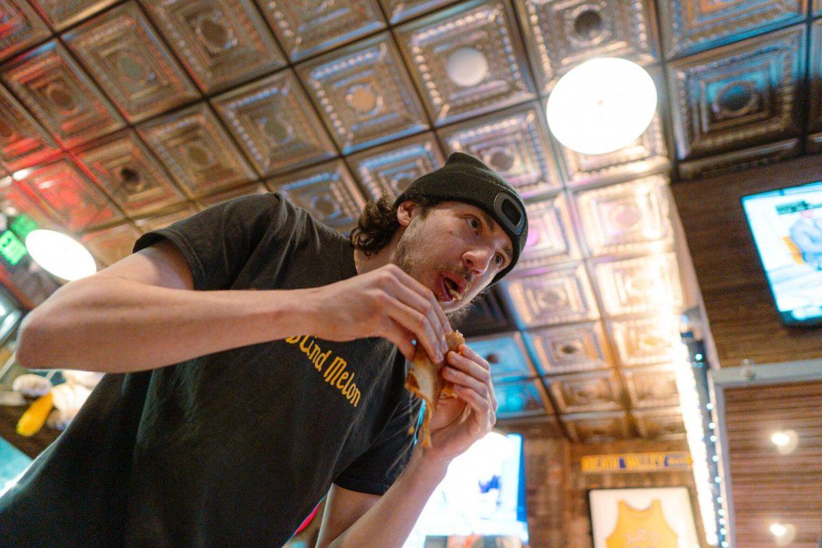 Jacob Chastant chews on a portion of the pizza Sunday, Feb. 18, 2024, at Fat Boy's Pizza on Nicholson Drive in Baton Rouge, La.