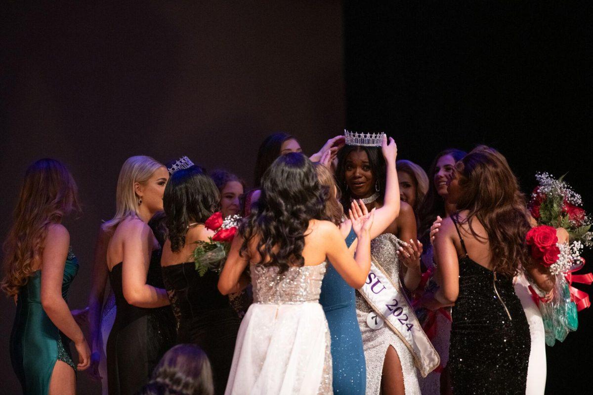 Other contestants surround kinesiology sophomore and Miss LSU 2024 Nikhia Sims Sunday, March 24, 2024, after Delta Zeta's Miss LSU 2024 Pageant in the Union Theater in Baton Rouge, La.