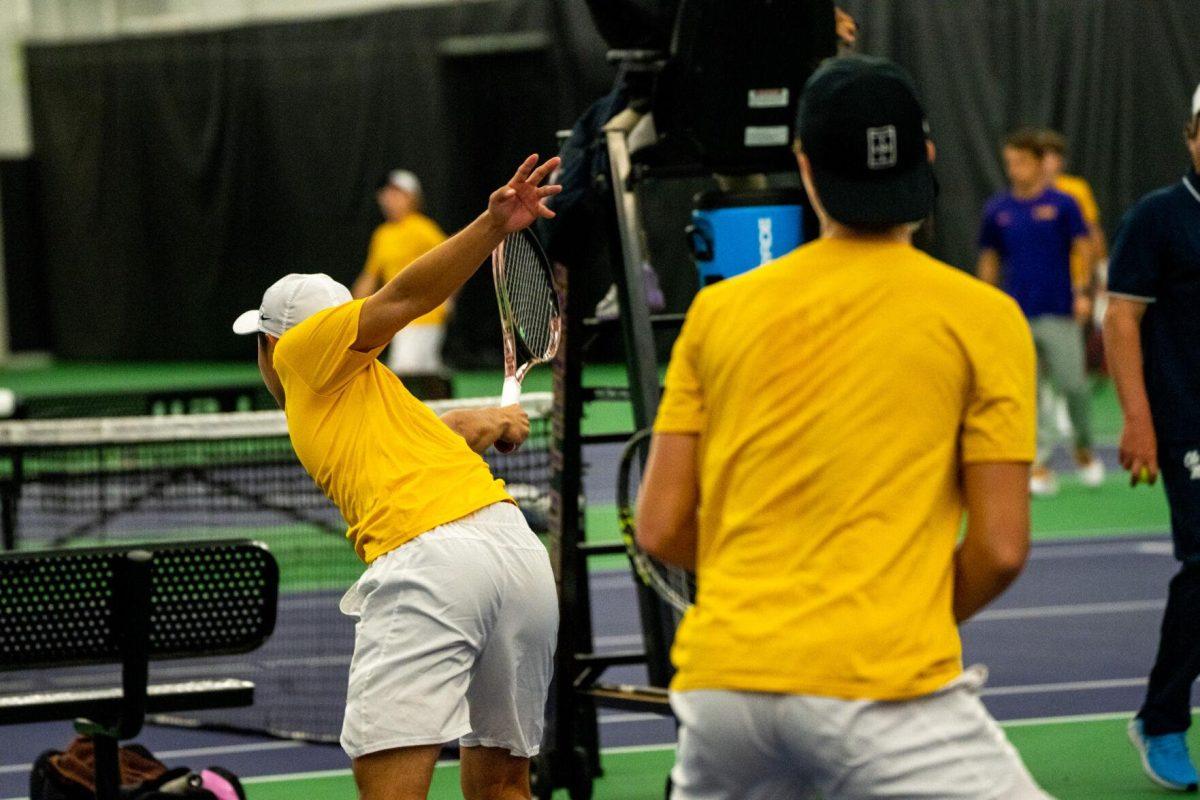 LSU men's tennis senior Chen Dong hits a backhand with junior Julien Penzlin at the net during their unfinished 7-6, 5-5 doubles match against Ole Miss Friday, March 8, 2024, at the LSU tennis complex on Gourrier Avenue in Baton Rouge, La.