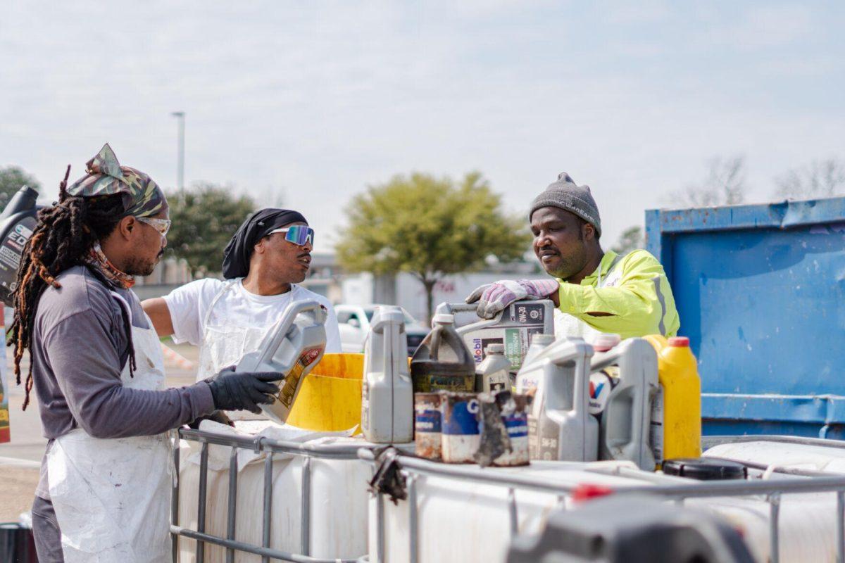 Workers pour liquids into a large container Saturday, March 2, 2024, at the Household Hazardous Materials Collection Day on LSU's campus in Baton Rouge, La.