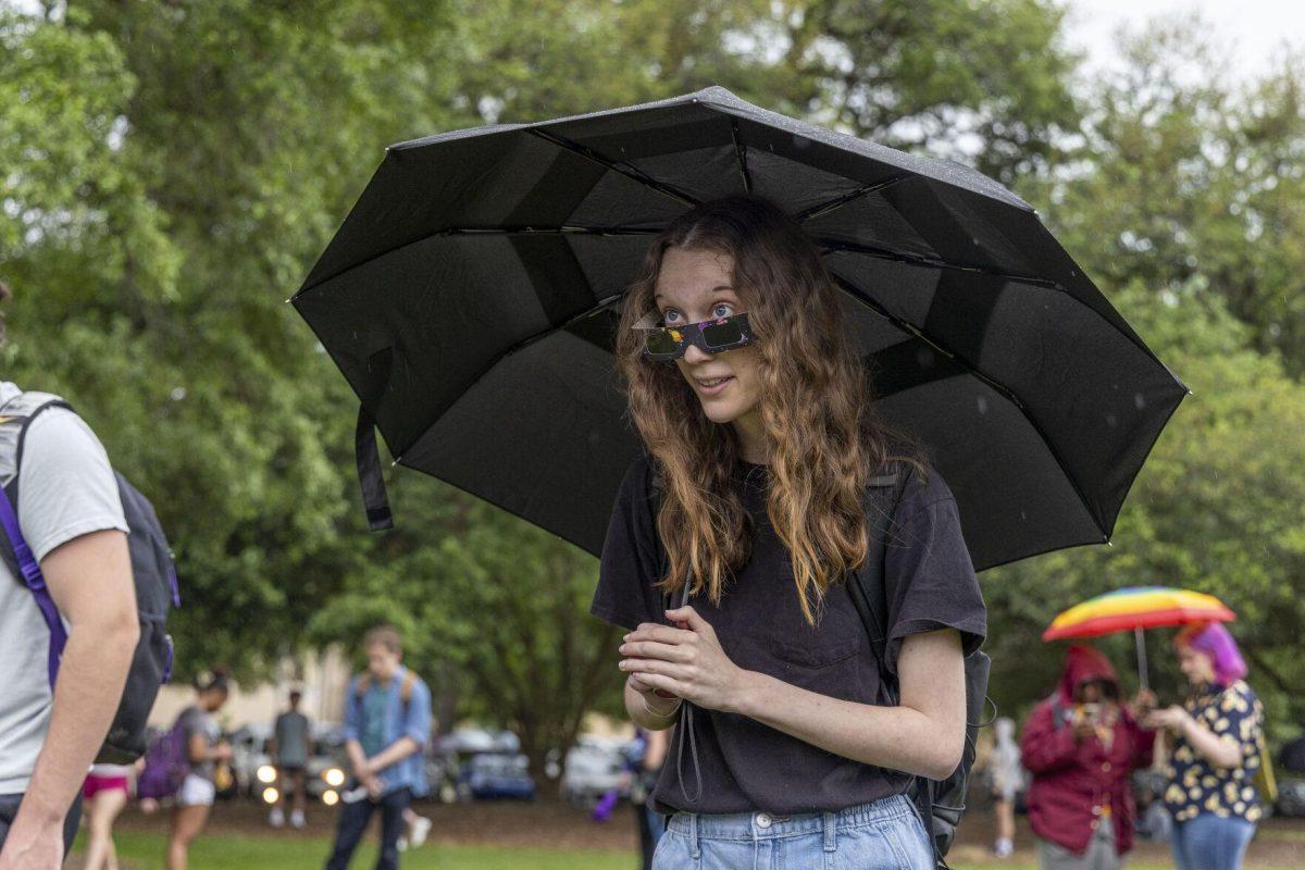 An LSU student tries on her solar eclipse glasses Monday, April 8, 2024, in anticipation of seeing the 2024 Solar Eclipse on the LSU Parade Ground.