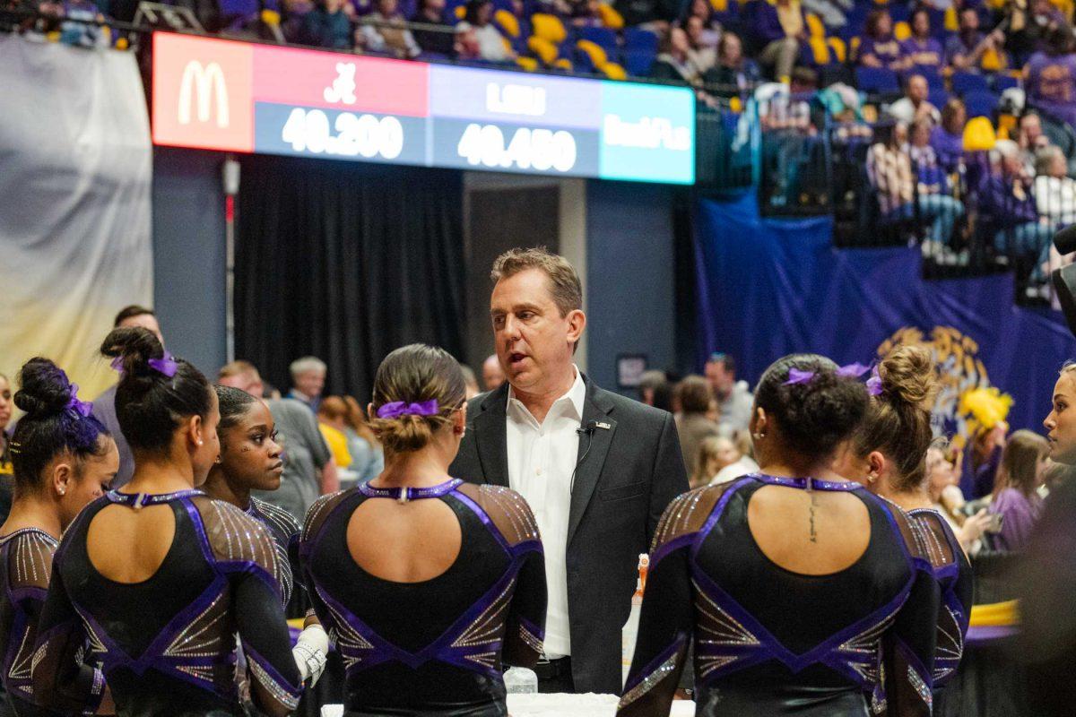 LSU gymnastics head coach Jay Clark talks with the team Friday, March 1, 2024, during LSU&#8217;s 198.325-197.325 win against Alabama in the Pete Maravich Assembly Center in Baton Rouge, La.