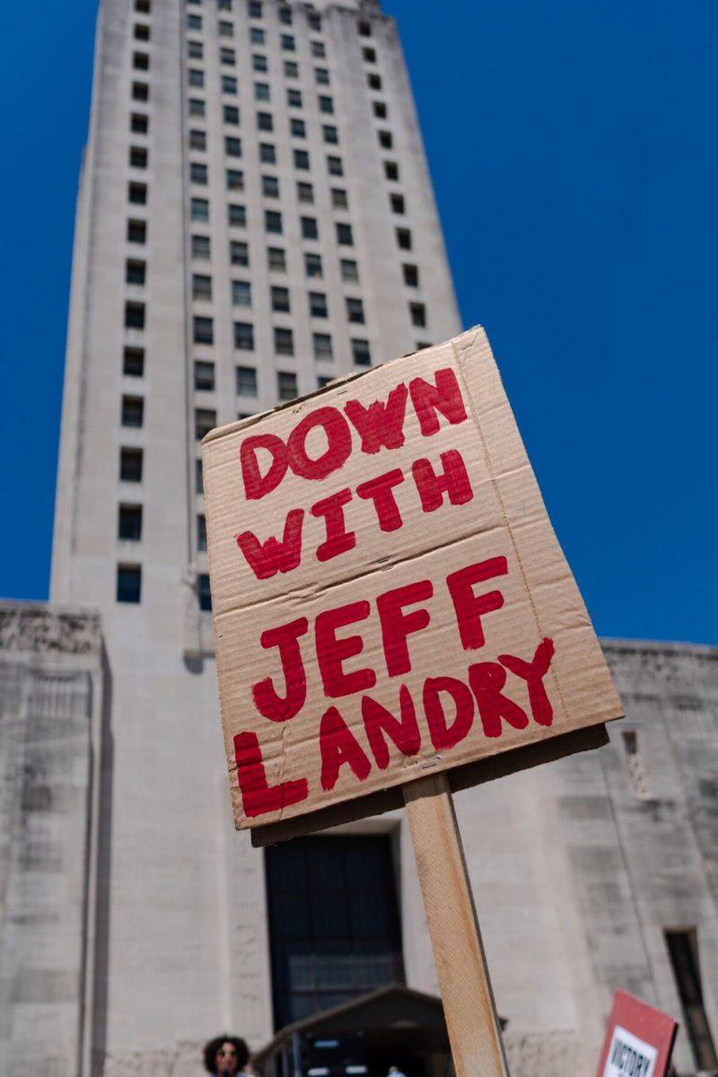 A sign reads "Down with Jeff Landry" Monday, April 22, 2024, at a protest at the Capitol in Baton Rouge, La.