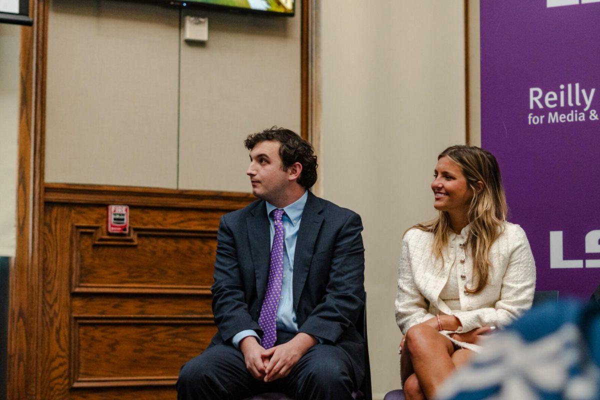 Joseph Liberto and Amelia Carman listen to the speaker Wednesday, April 17, 2024, at the Inauguration in the Holliday Forum on LSU's campus in Baton Rouge, La.