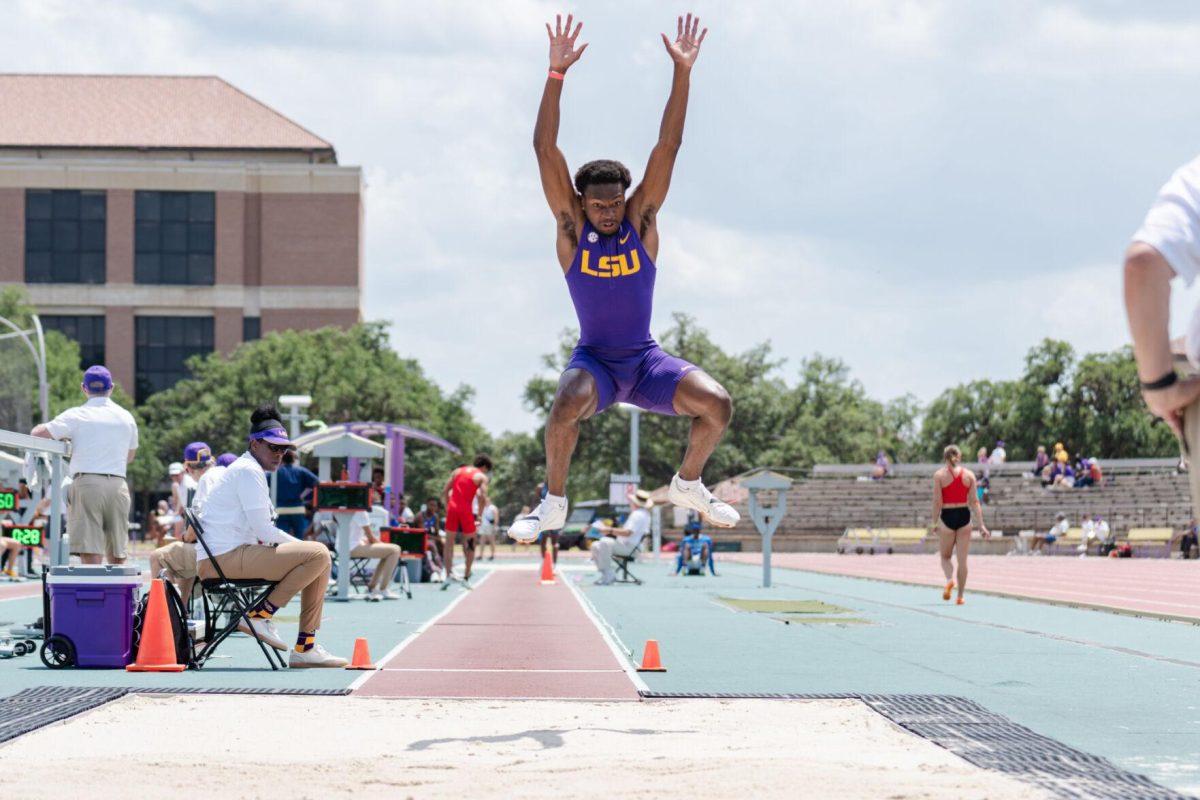 LSU track and field jumps senior Ji'eem Bullock flies through the air as he compete in long jump Saturday, April 27, 2024, at the LSU Invitational in the Bernie Moore Track Stadium in Baton Rouge, La.