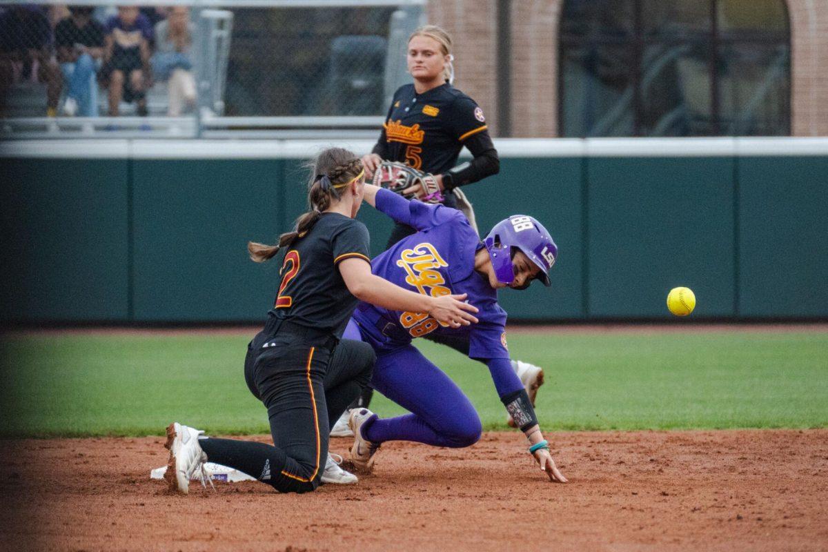 LSU softball graduate student outfielder Ciara Briggs (88) stands up as the ball gets loose Tuesday, April 2, 2024, during LSU's 7-4 win against ULM in Tiger Park in Baton Rouge, La.