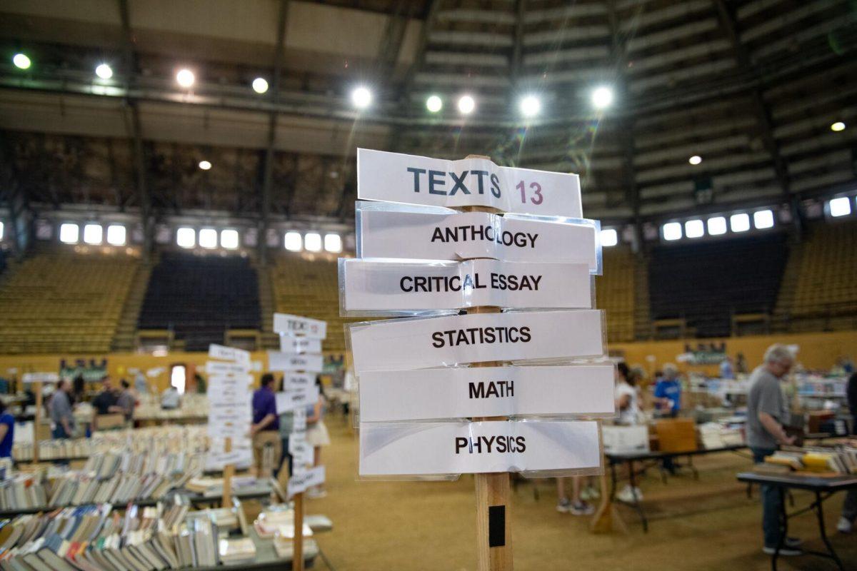 Signs list book genres Sunday, April 14, 2024, during the Friends of the LSU Libraries Book Bazaar at the John M. Parker Agricultural Coliseum in Baton Rouge, La.