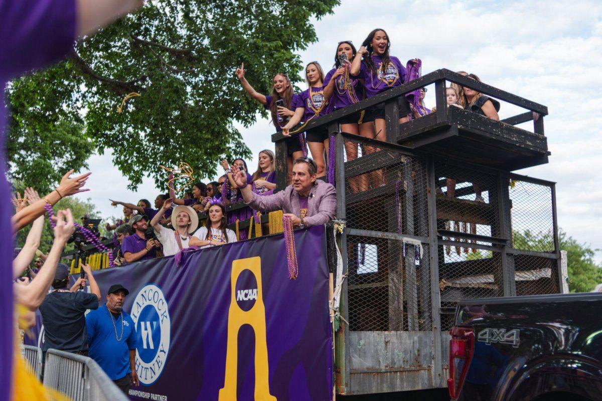 Members of the LSU gymnastics team throw beads from a float Wednesday, April 24, 2024, at the LSU gymnastics championship parade on LSU's campus in Baton Rouge, La.