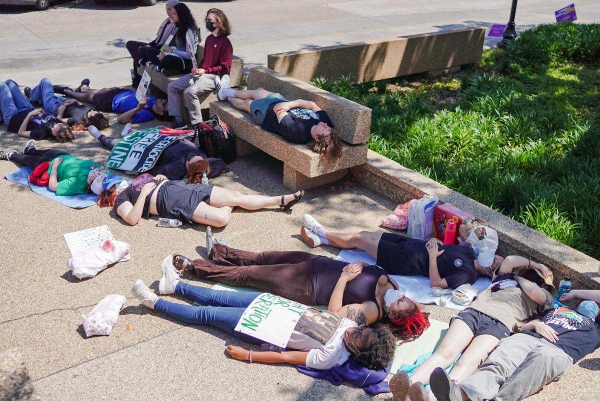 Students lie on the LSU Student Union steps Thursday, April 25, 2024, during the Die-in for Gaza on LSU&#8217;s campus in Baton Rouge, La.