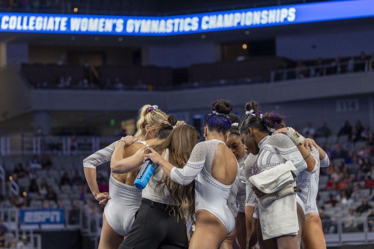 The LSU gymnastics floor team huddles up Saturday, April 20, 2024, during the NCAA Gymnastics Championship in the Dickies Arena in Fort Worth, Tx.