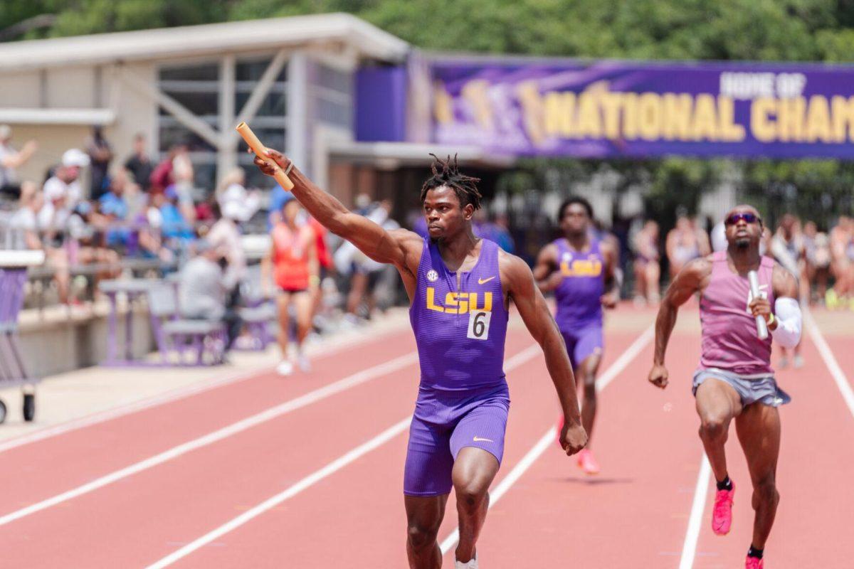 LSU track and field junior sprinter Godson Oghenebrume holds up the baton after crossing the finish line in the 4x100 meter relay Saturday, April 27, 2024, at the LSU Invitational in the Bernie Moore Track Stadium in Baton Rouge, La.