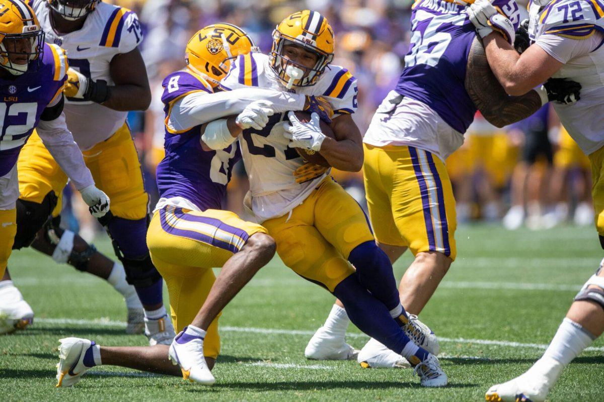 LSU football graduate student running back Josh Williams (27) protects the ball during the LSU Spring Football game on Saturday, April 13, 2024, in Tiger Stadium.