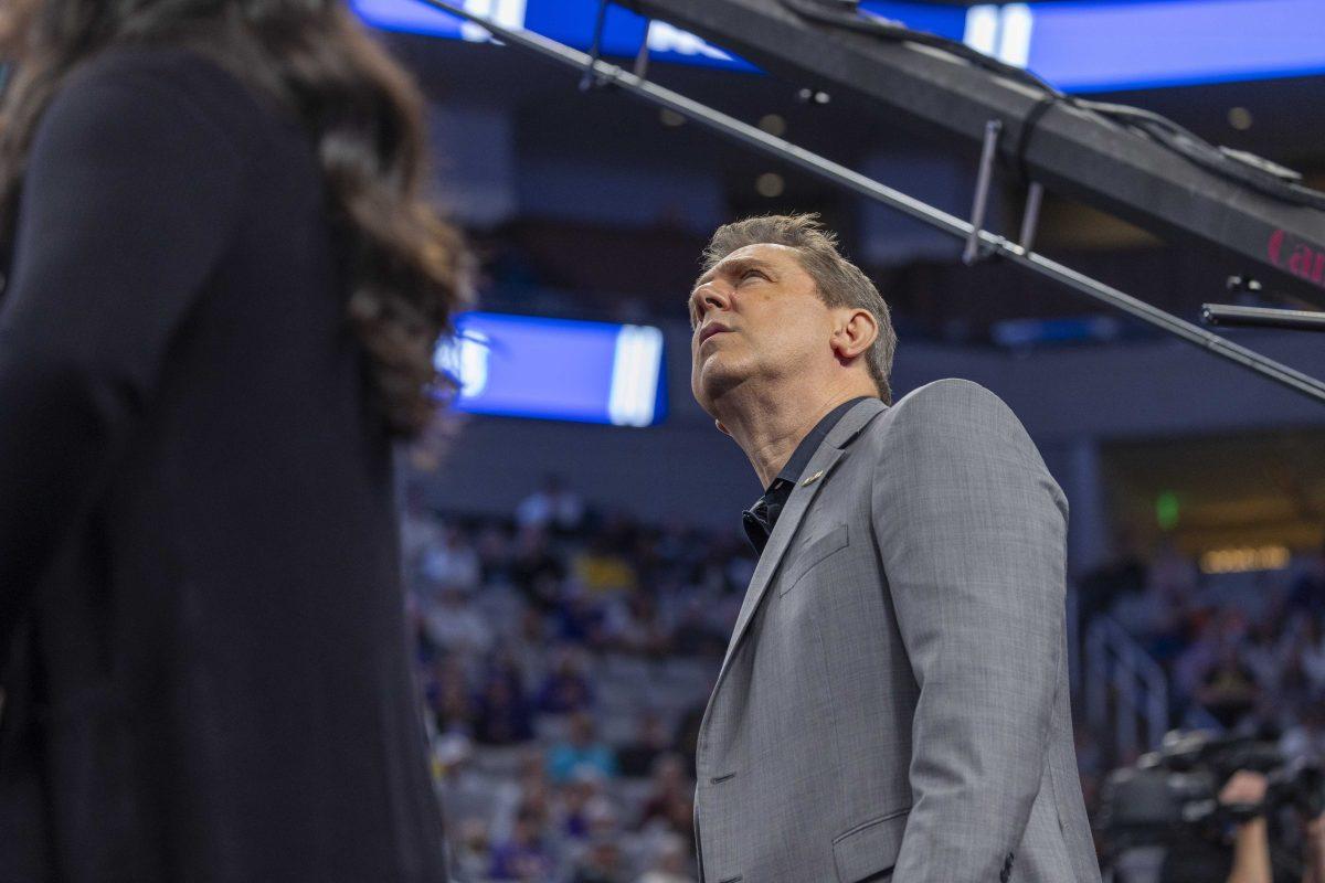 LSU gymnastics head coach Jay Clark checks the score board Saturday, April 20, 2024, during the NCAA Gymnastics Championship in the Dickies Arena in Fort Worth, Tx.