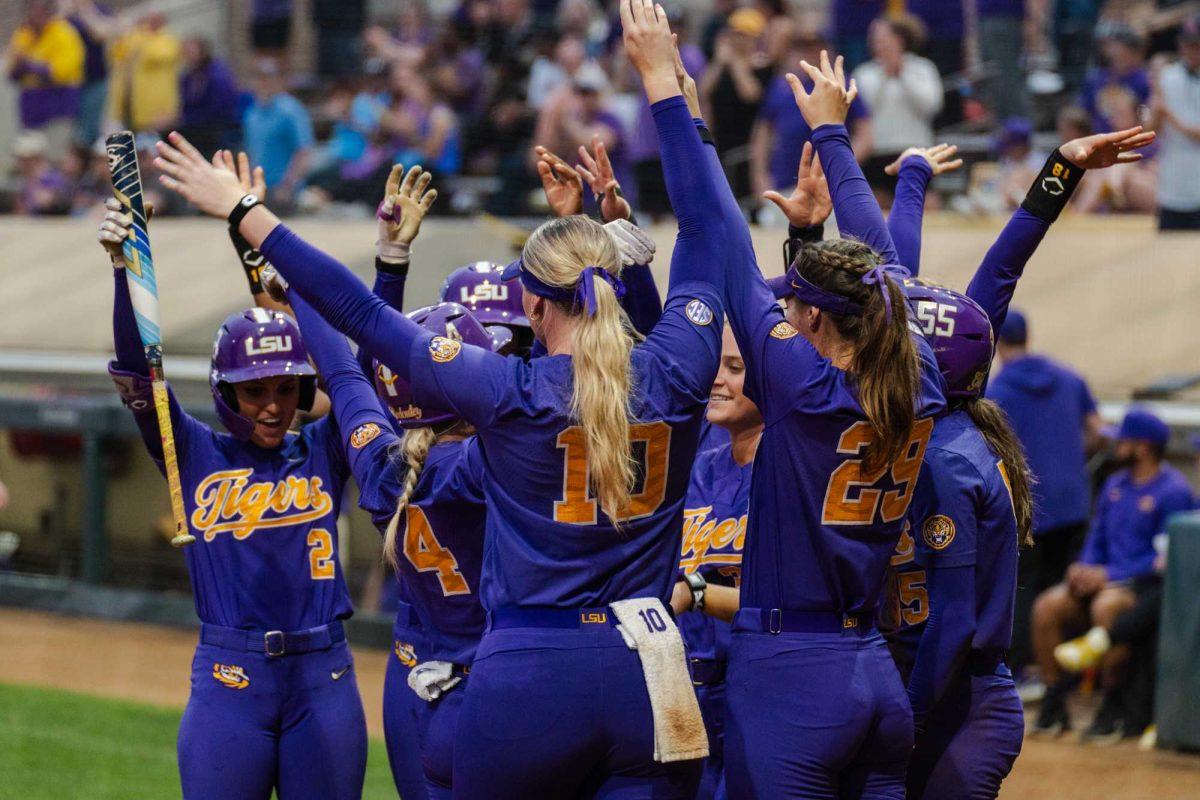 The LSU softball team celebrates McKenzie Redoutey's home run Tuesday, April 2, 2024, during LSU's 7-4 win against ULM in Tiger Park in Baton Rouge, La.