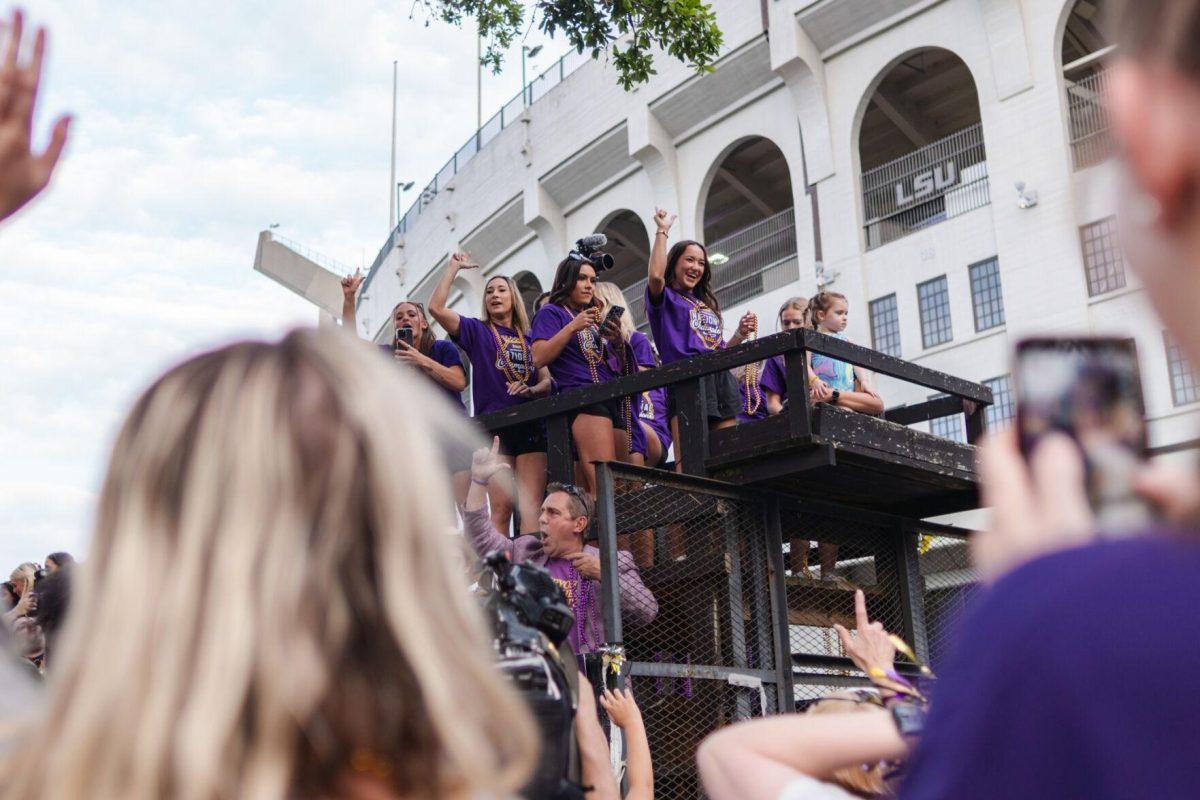 Members of the LSU gymnastics team throw beads from a float Wednesday, April 24, 2024, at the LSU gymnastics championship parade on LSU's campus in Baton Rouge, La.