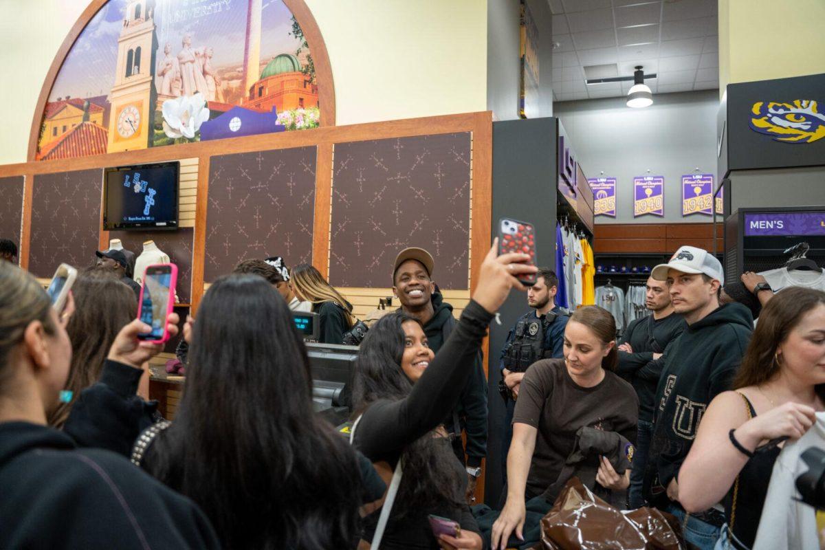 Travis Scott takes a selfie with a student Thursday, April 4, 2024, at the Barnes &amp; Nobles at LSU in Baton Rouge, La.