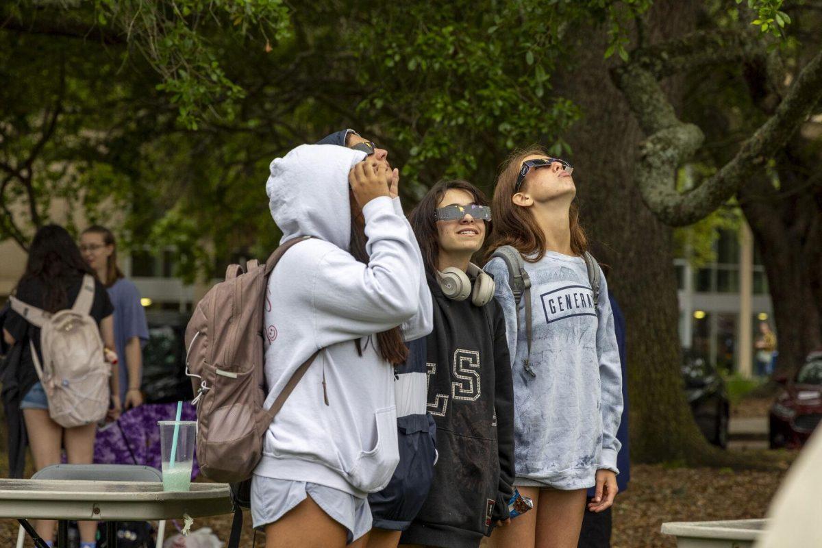 LSU students hope for the sky to clear up Monday, April 8, 2024, in anticipation of seeing the 2024 Solar Eclipse on the LSU Parade Ground.