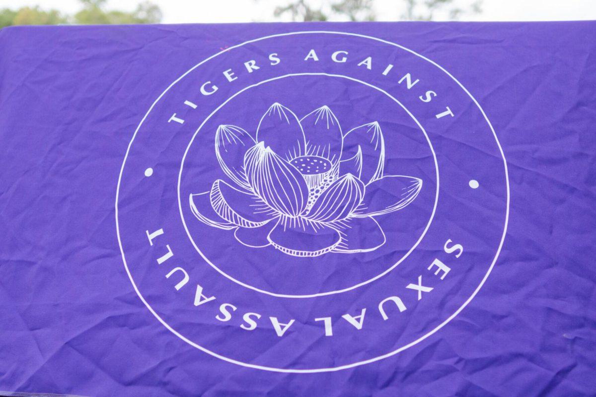 A table cloth reads "Tigers Against Sexual Assault" Wednesday, April 24, 2024, during a Denim Day event at the LSU amphitheater.