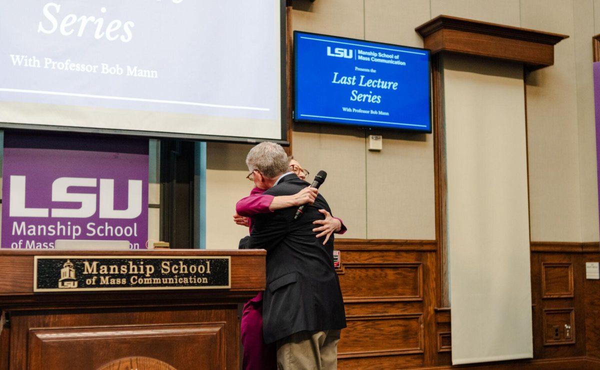 Professional-in-Residence Alyson Neel hugs Professor Bob Mann Wednesday, April 17, 2024, at the Last Lecture Series in the Holliday Forum at LSU in Baton Rouge, La.
