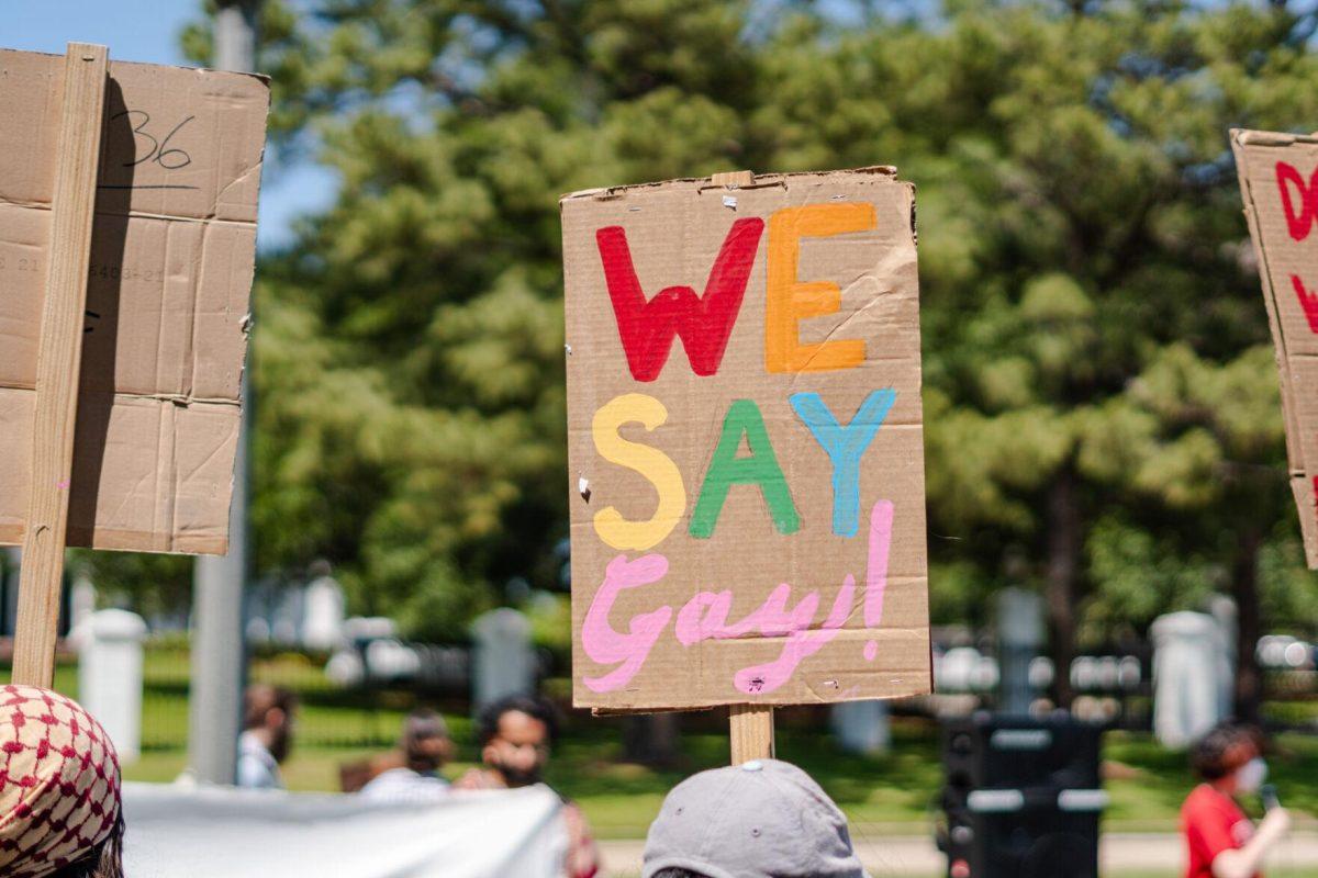 A sign reads "We Say Gay!" Monday, April 22, 2024, during a protest outside the Governor's mansion in Baton Rouge, La.