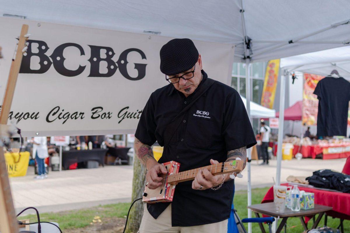Gerard Guidoni of Lafayette plays a cigar box guitar Saturday, April 20, 2024, at the Baton Rouge Blues Festival.