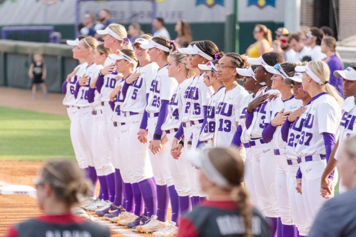 The LSU softball team stands for the national anthem Friday, April 26, 2024, during LSU's 2-1 loss against Arkansas at Tiger Park in Baton Rouge, La.