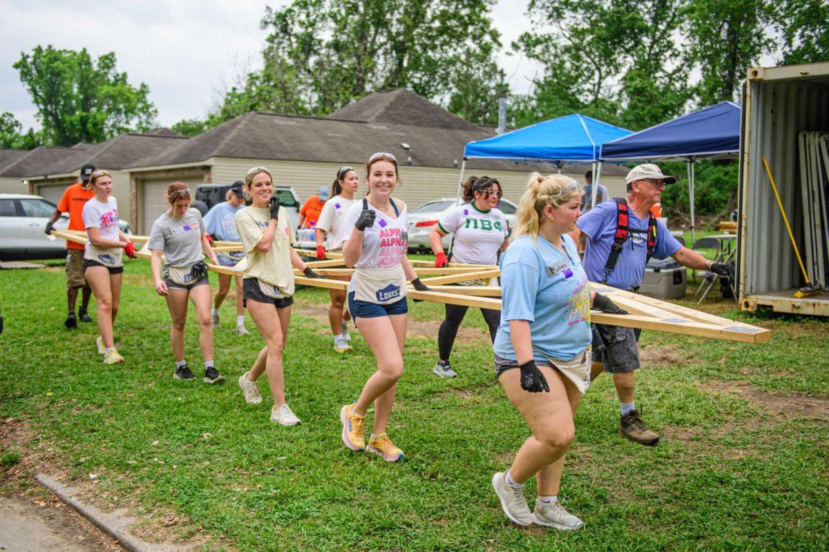 LSU students smile as they help with construction on Tuesday, April 9, 2024, on Fountain Avenue in Baton Rouge, La.