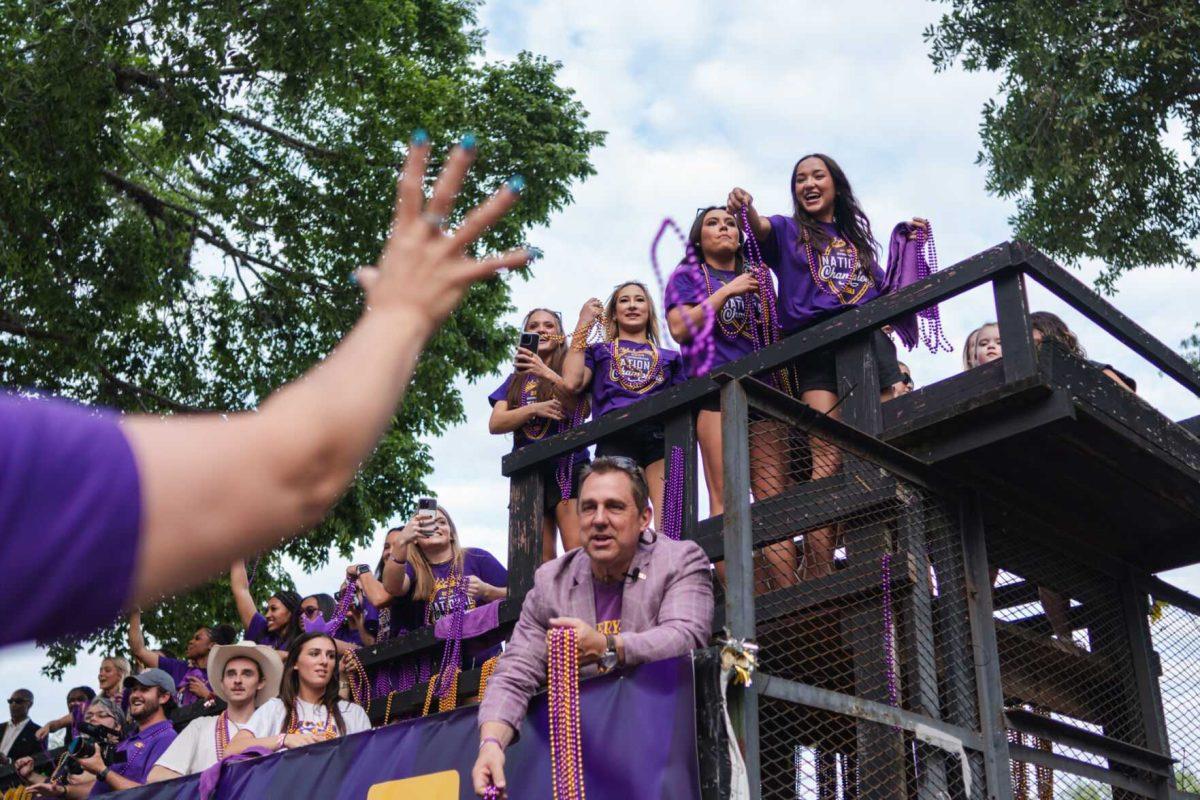 Members of the LSU gymnastics team throw beads from a float Wednesday, April 24, 2024, at the LSU gymnastics championship parade on LSU's campus in Baton Rouge, La.