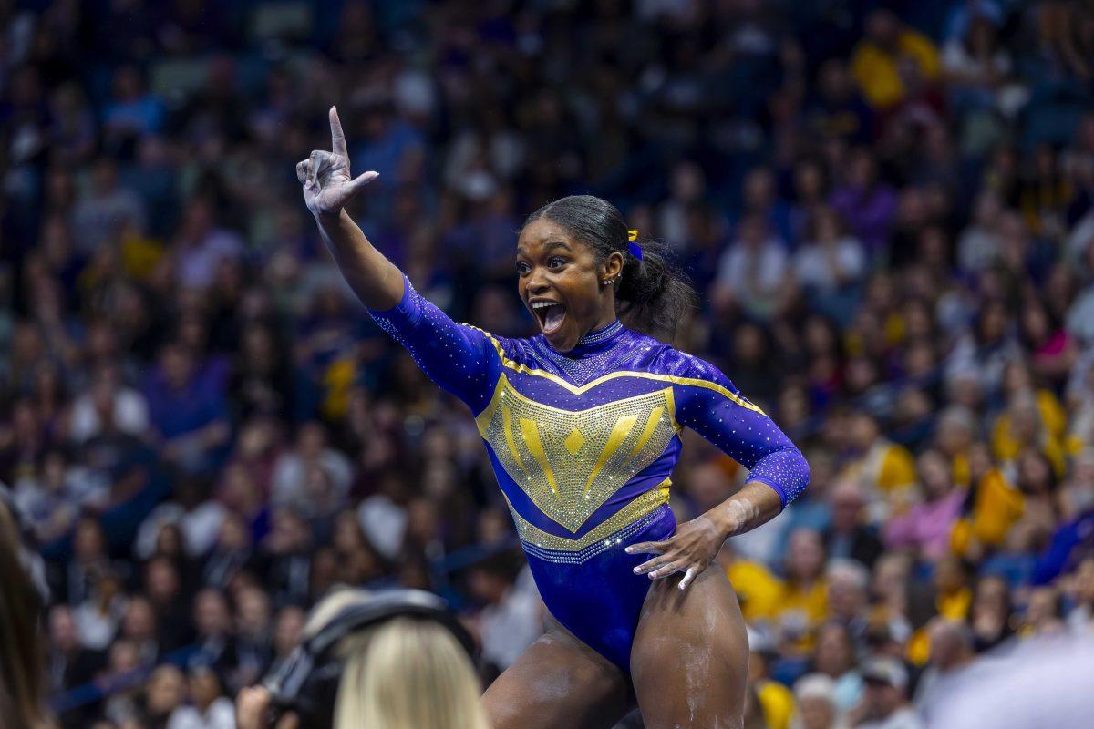 LSU gymnastics graduate student all-around Kiya Johnson makes a "L" Saturday, March 23, 2024, during LSU's 198.075 victory in the 2024 SEC Gymnastics Championship in the Smoothie King Center in New Orleans, La.