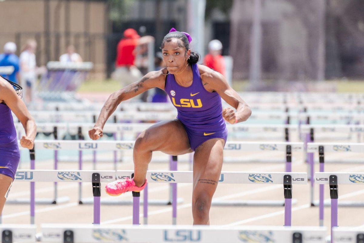 LSU track and field sprints senior Shani'a Bellamy clears a hurdle Saturday, April 27, 2024, at the LSU Invitational in the Bernie Moore Track Stadium in Baton Rouge, La.