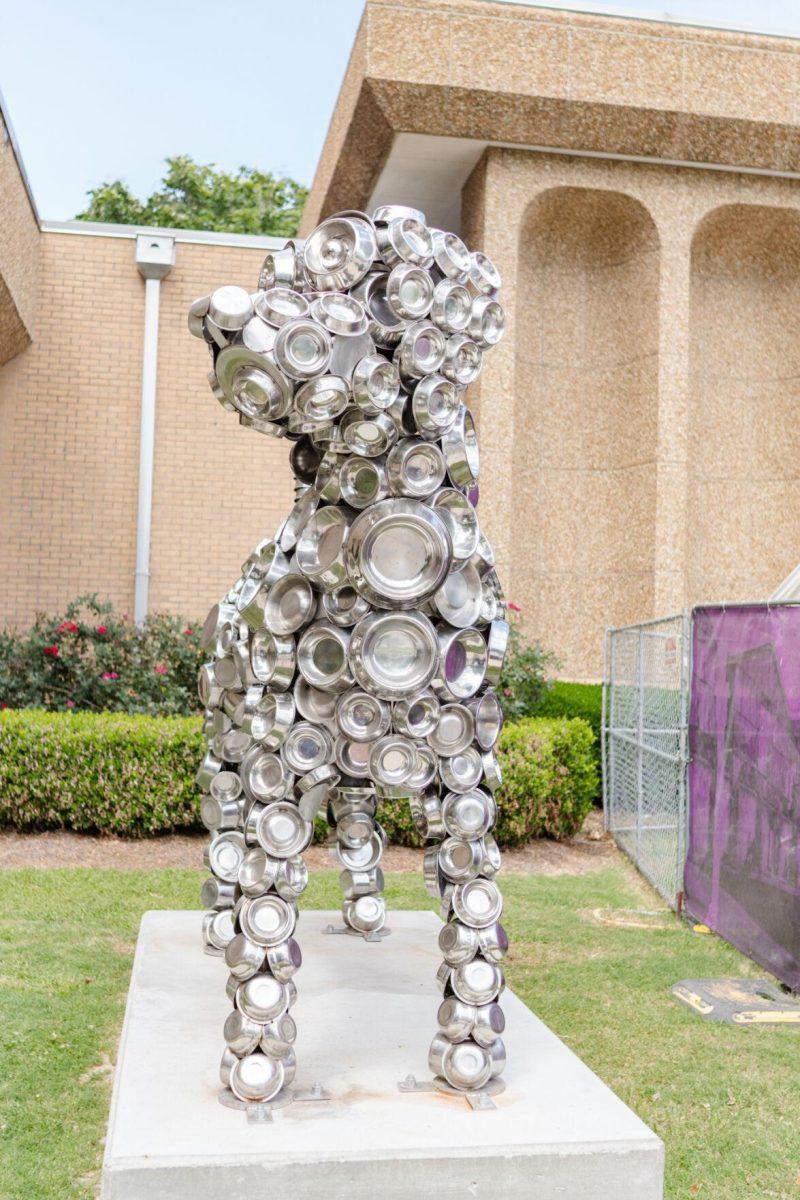 A dog statue made of dog bowls sits Friday, April 26, 2024, outside of the LSU School of Veterinary Medicine in Baton Rouge, La.