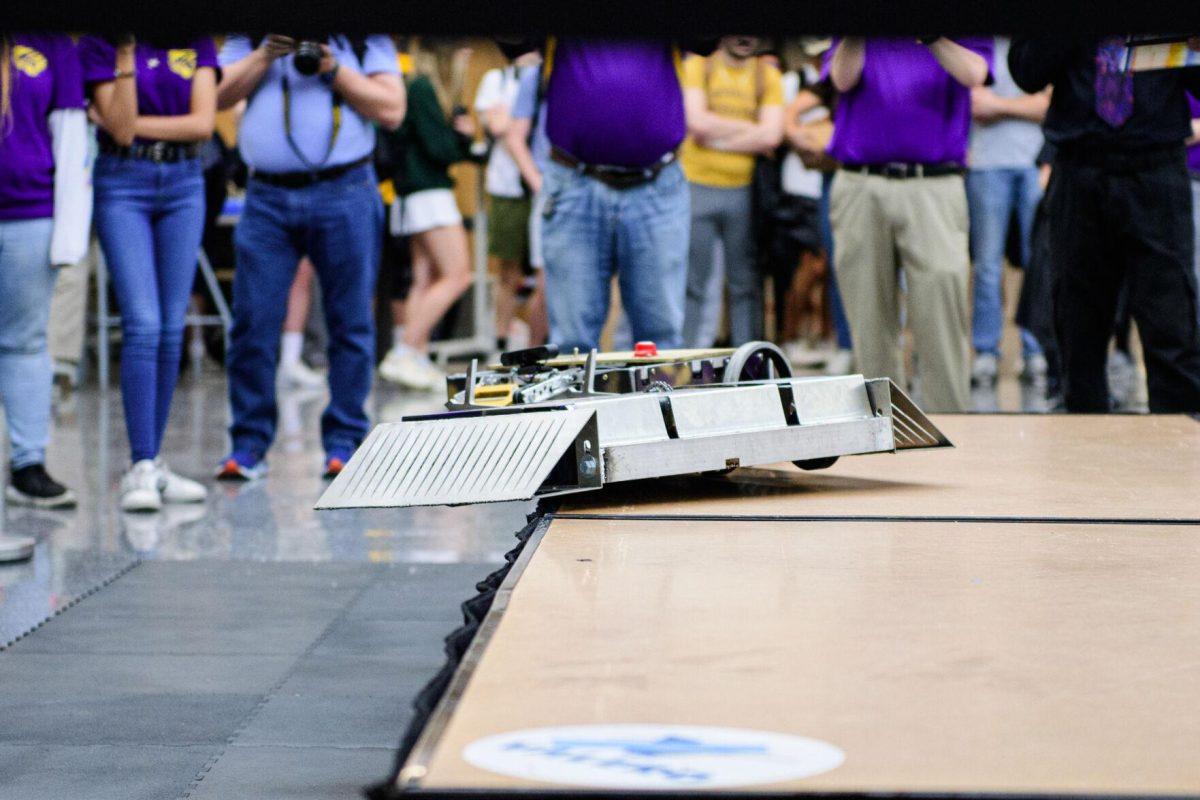 The robots teeter on the edge of the platform on Tuesday, April 16, 2024, at the Bengal Bot Brawl in Patrick F. Taylor Hall in Baton Rouge, La.