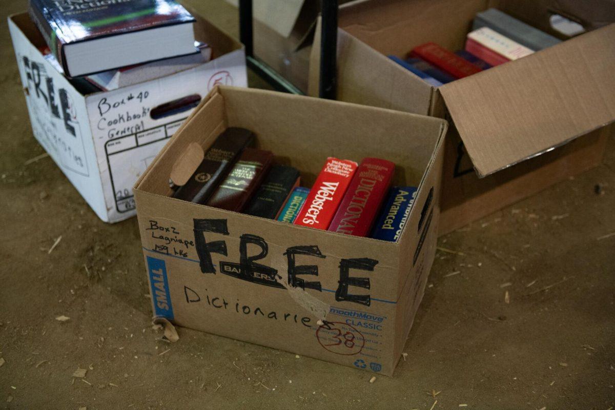 Free dictionaries sit in a box Sunday, April 14, 2024, during the Friends of the LSU Libraries Book Bazaar at the John M. Parker Agricultural Coliseum in Baton Rouge, La.