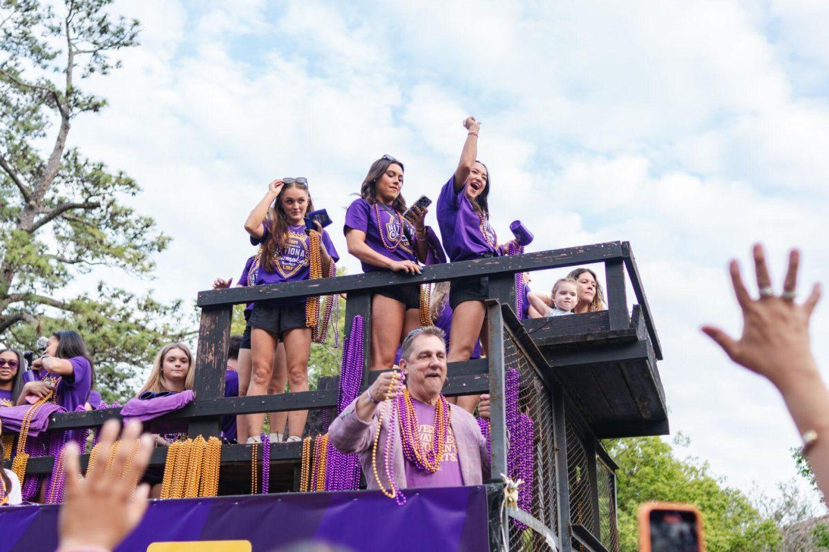 Members of the LSU gymnastics team throw beads from a float Wednesday, April 24, 2024, at the LSU gymnastics championship parade on LSU's campus in Baton Rouge, La.