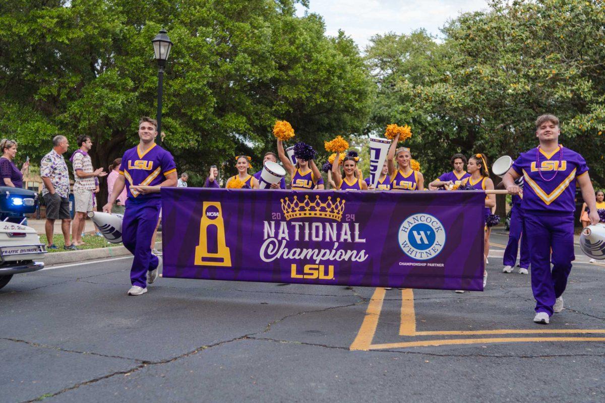 The parade begins with the LSU cheerleaders leading Wednesday, April 24, 2024, at the LSU gymnastics championship parade on LSU's campus in Baton Rouge, La.