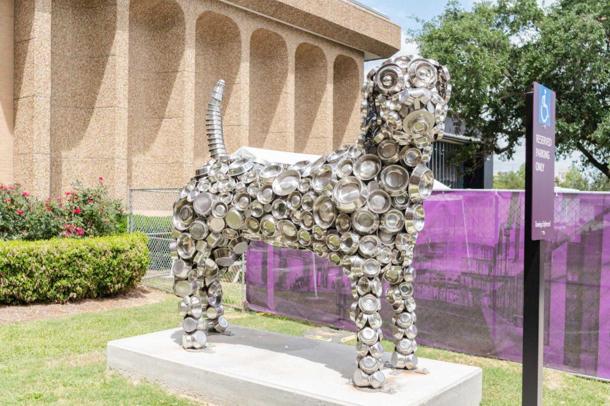 A dog statue made of dog bowls sits Friday, April 26, 2024, outside of the LSU School of Veterinary Medicine in Baton Rouge, La.