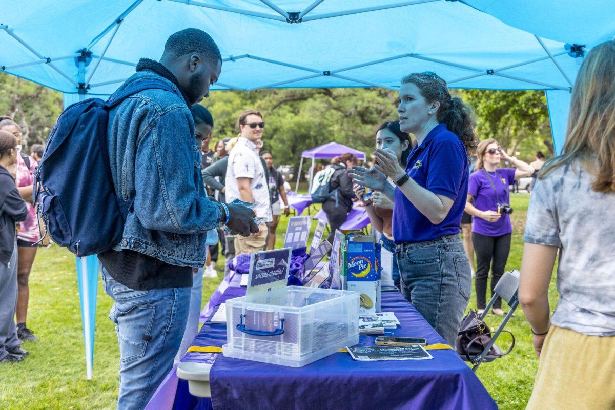 A student picks up a pair of solar eclipse glasses Monday, April 8, 2024, in anticipation of seeing the 2024 Solar Eclipse on the LSU Parade Ground.
