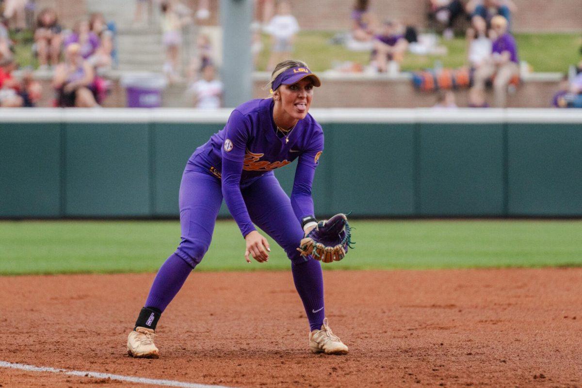 LSU softball freshman utility Maddox McKee (2) sticks her tongue out as she readies for the play Tuesday, April 2, 2024, during LSU's 7-4 win against ULM in Tiger Park in Baton Rouge, La.